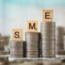 Stack,Of,Coins,With,Wooden,Letters