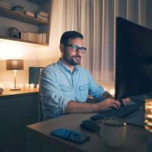 Modern,Young,Man,Working,Remotely,From,Home,At,Night.