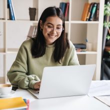 Attractive,Happy,Young,Girl,Student,Studying,At,The,College,Library,