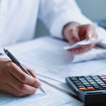 Man,Hand,Filling,Us,Tax,Form.,Tax,Form,Us,Business