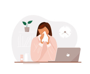 Young,Woman,With,Flu,Sitting,At,Laptop,In,Office,Until