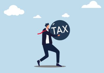 Businessman,Carry,A,Heavy,Burden,With,The,Word,Tax.,A