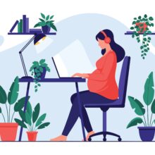 Pregnant,Woman,Wearing,Headphones,Works,On,Her,Laptop,At,A