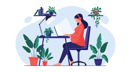 Pregnant,Woman,Wearing,Headphones,Works,On,Her,Laptop,At,A
